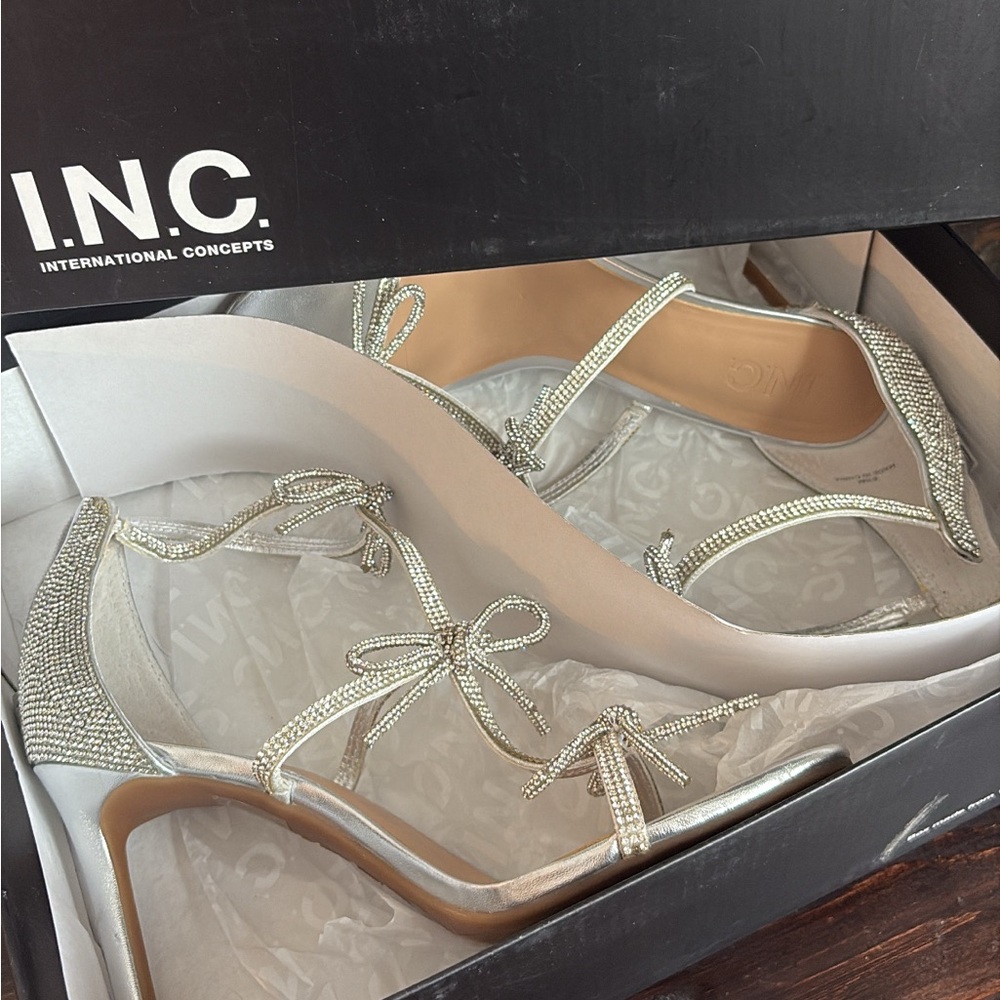 INC International Concepts Women's Glittering Silver Heels with bows on front.